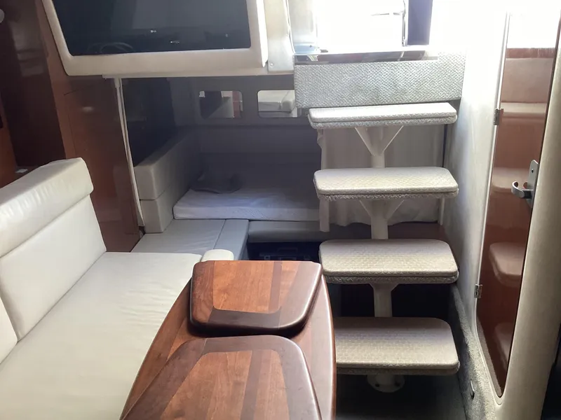 Slide: The Image of Interior of 2008 Sea Ray 350 Sundancer yacht with wooden table and stairs. - 16