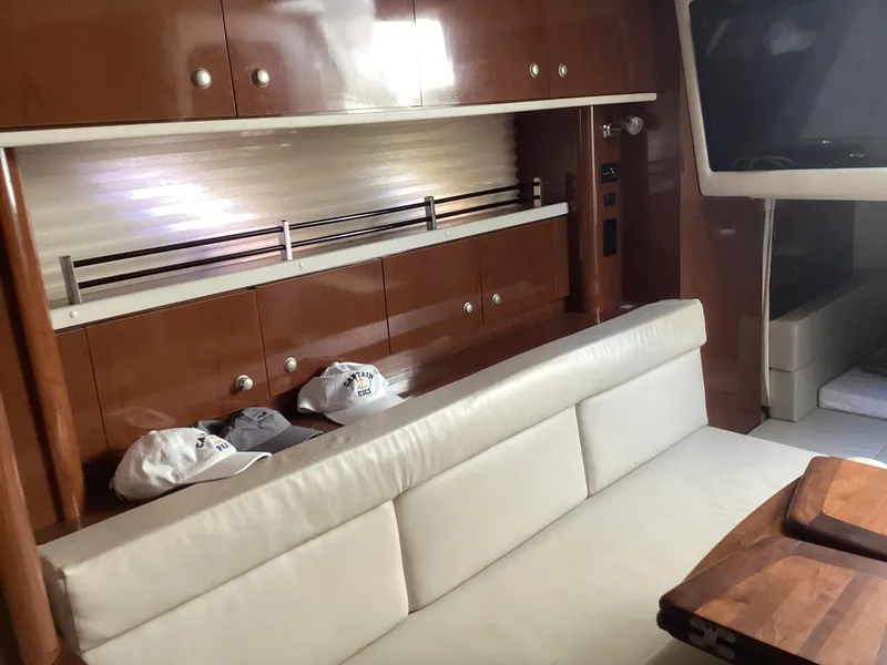Slide: The Image of Interior of 2008 Sea Ray 350 Sundancer with leather seating and wooden cabinetry. - 23