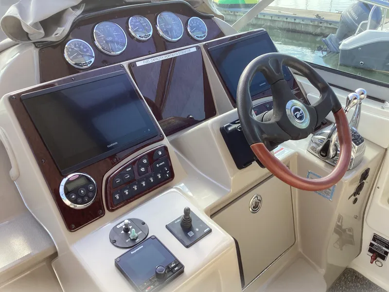 Slide: The Image of 2008 Sea Ray 350 Sundancer helm with dual screens and gauges. - 4
