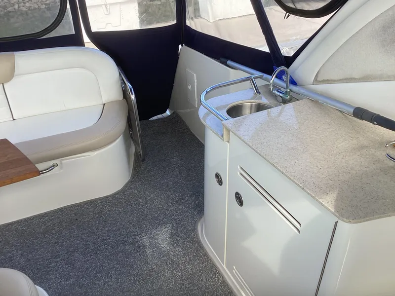 Slide: The Image of Interior of 2008 Sea Ray 350 Sundancer with seating and kitchenette. - 7