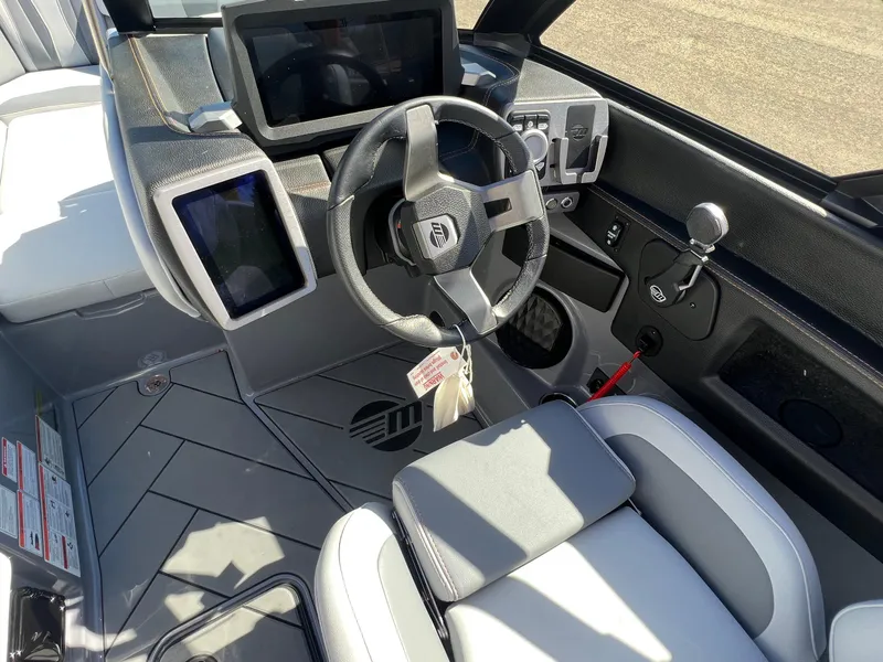Slide: The Image of 2023 Malibu Wake Setter LSV 22 boat interior with modern dashboard and steering wheel. - 18