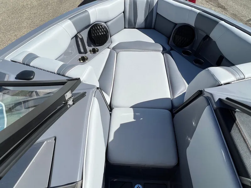 Slide: The Image of 2023 Malibu Wake Setter LSV 22 interior with gray seating and cup holders. - 22
