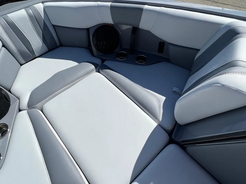 Slide: The Image of 2023 Malibu Wake Setter LSV 22 interior with gray seating and cup holders. - 23