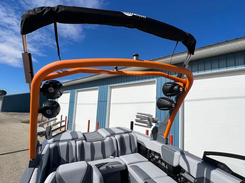 Slide: The Image of 2023 Malibu Wake Setter LSV 22 boat with orange wakeboard tower and speakers. - 27