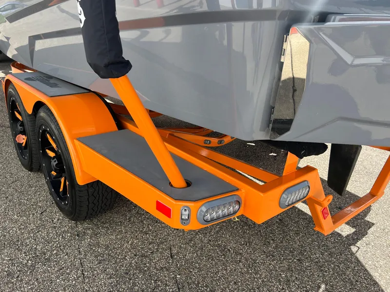 Slide: The Image of 2023 Malibu Wake Setter LSV 22 on orange trailer, close-up view. - 31