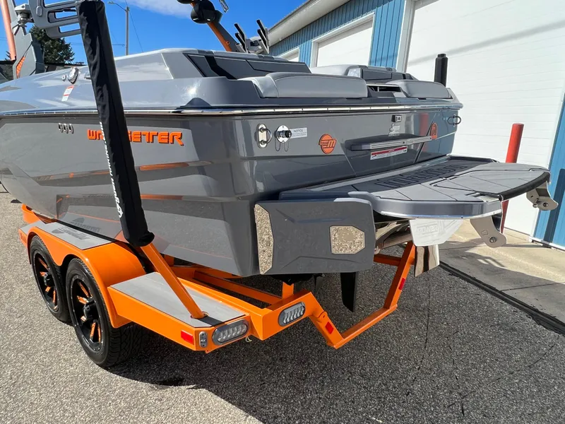 Slide: The Image of 2023 Malibu Wake Setter LSV 22 boat on orange trailer, rear view. - 37