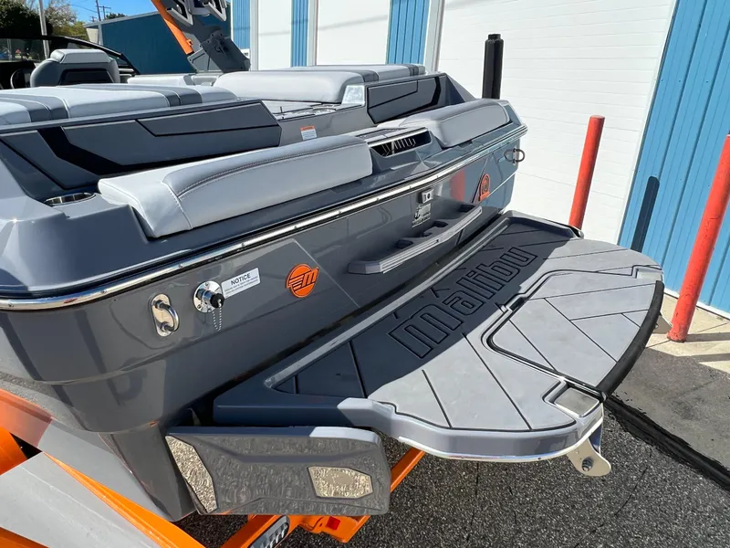 Slide: The Image of 2023 Malibu Wake Setter LSV 22 boat rear view with swim platform and sleek design. - 38