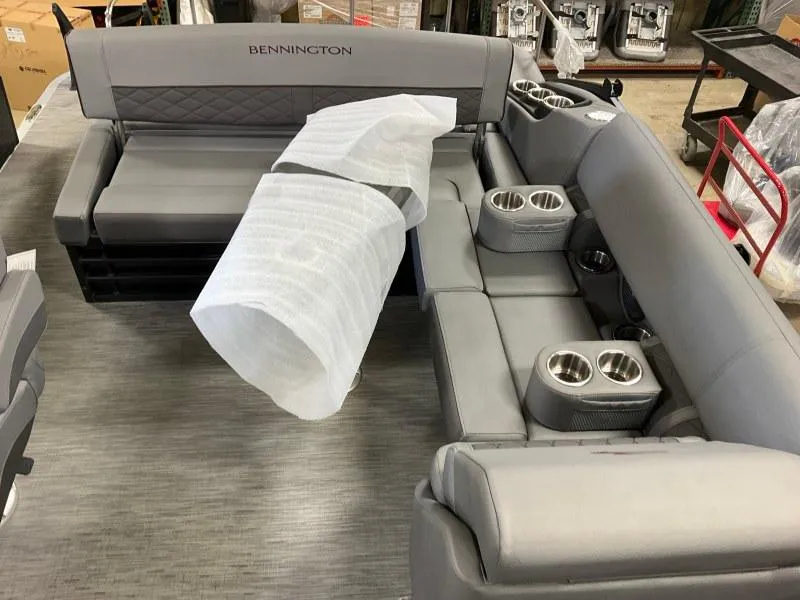 Slide: The Image of 2023 Bennington 21LSB boat seating with cup holders in a showroom. - 10
