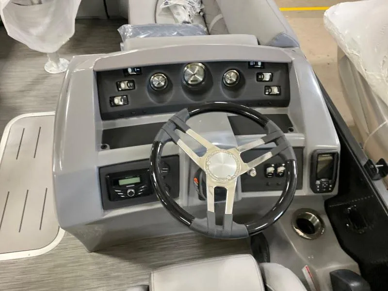 Slide: The Image of 2023 Bennington 21LSB boat dashboard with steering wheel and control panel. - 14