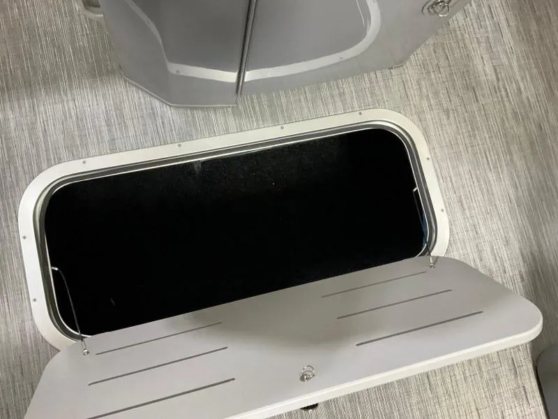 Slide: The Image of Open storage compartment on 2023 Bennington 21LSB boat, showcasing interior space. - 17