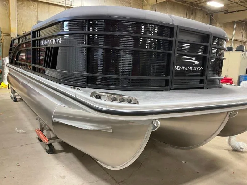 Slide: The Image of 2023 Bennington 21LSB pontoon boat in a showroom, showcasing sleek design and modern features. - 4
