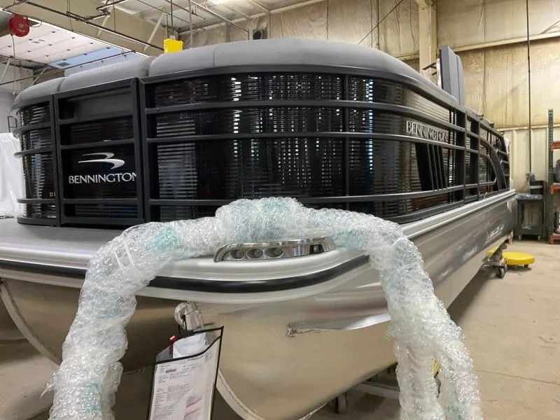 Slide: The Image of 2023 Bennington 21LSB pontoon boat in a warehouse setting. - 5