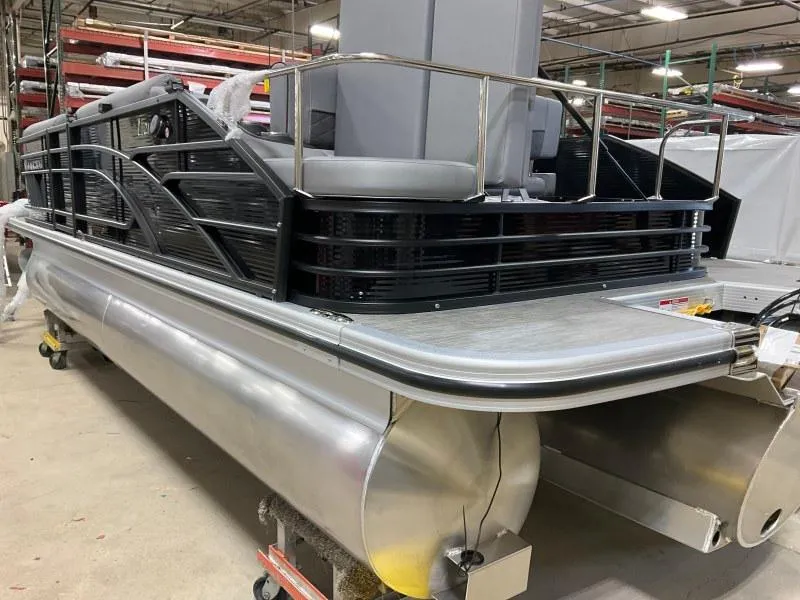 Slide: The Image of 2023 Bennington 21LSB pontoon boat in a warehouse setting. - 7