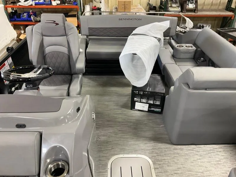 Slide: The Image of 2023 Bennington 21LSB boat interior with gray seating and steering wheel. - 8