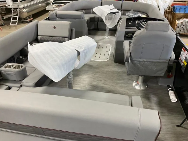 Slide: The Image of 2023 Bennington 21LSB pontoon boat interior with gray seating and helm. - 9