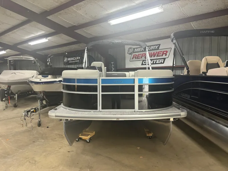 Slide: The Image of 2025 Harris Cruiser 190 pontoon boat in indoor showroom. - 2
