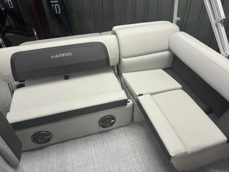 Slide: The Image of 2025 Harris Cruiser 190 boat seating with gray upholstery and integrated speakers. - 7