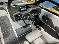 Slide: The Image of 2024 Cobalt CS23 boat interior with modern dashboard and steering wheel. - 10