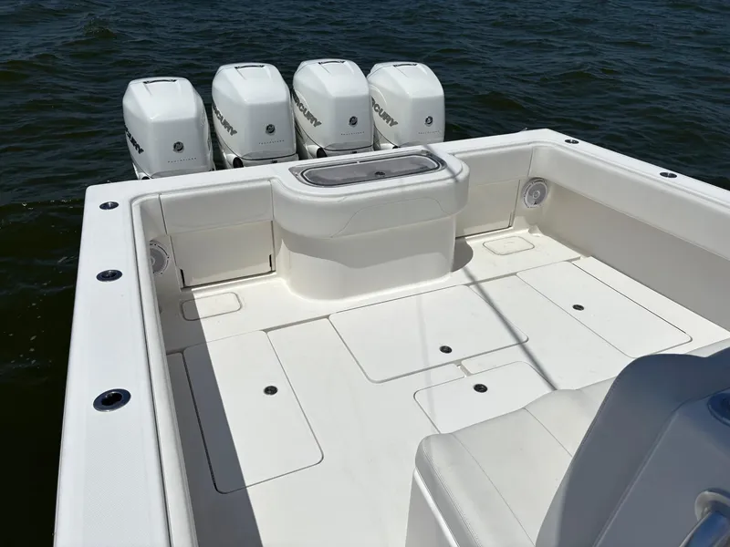 Slide: The Image of 2016 Invincible 42 Open Fisherman boat with four Mercury engines on open water. - 10