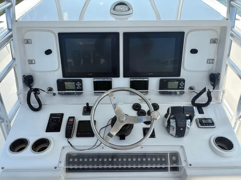 Slide: The Image of Control panel of 2016 Invincible 42 Open Fisherman boat with dual screens and steering wheel. - 14