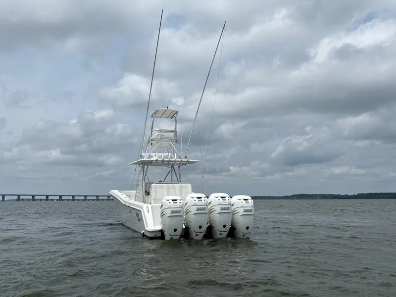 Slide: The Image of 2016 Invincible 42 Open Fisherman boat with four engines on a cloudy day. - 3