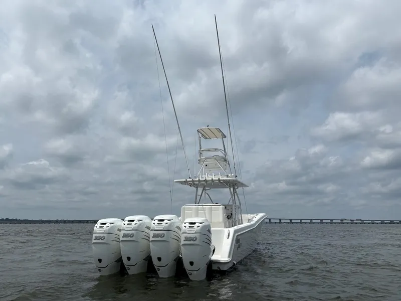 Slide: The Image of 2016 Invincible 42 Open Fisherman boat with four powerful engines on a cloudy day. - 5