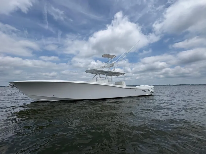 Slide: The Image of 2016 Invincible 42 Open Fisherman boat on calm water under cloudy sky. - 7