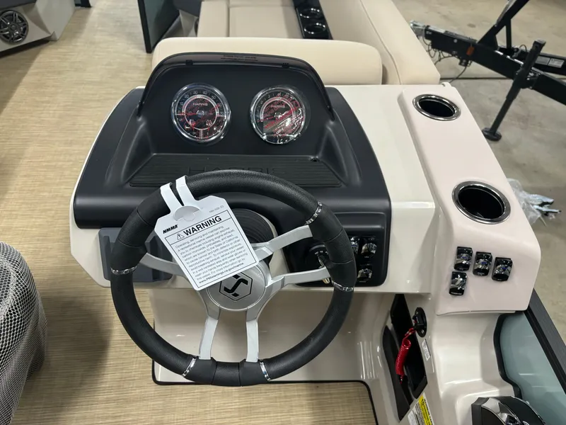 Slide: The Image of 2025 Harris Cruiser 230 dashboard with steering wheel and gauges. - 5