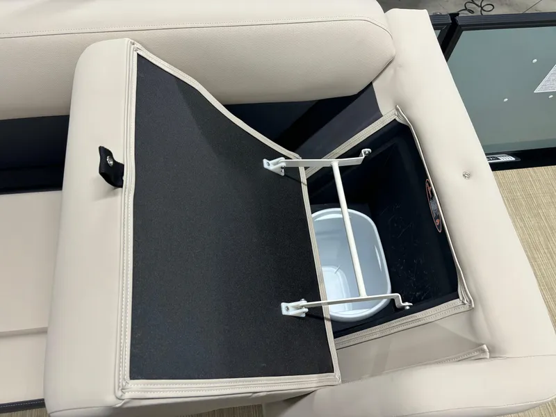 Slide: The Image of 2025 Harris Cruiser 230 boat seat storage compartment with integrated trash bin. - 6