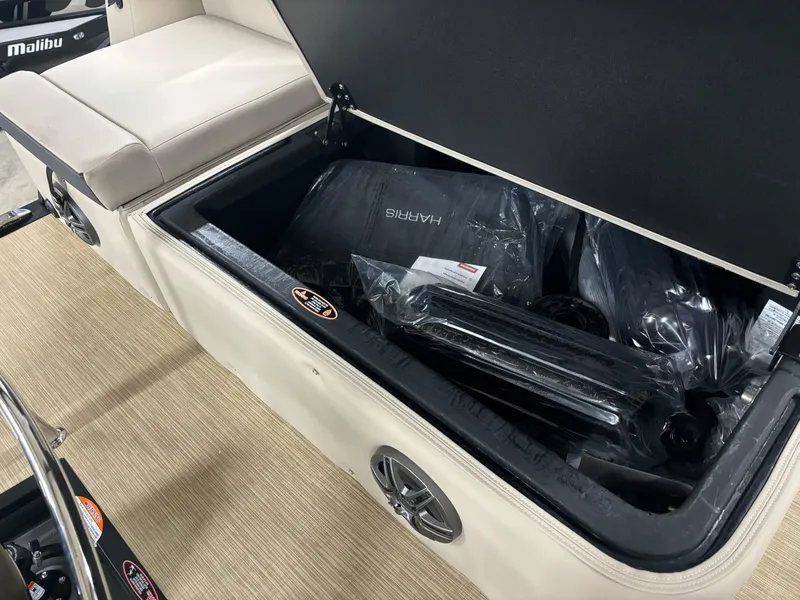 Slide: The Image of Open storage compartment in 2025 Harris Cruiser 230 boat, showcasing interior space and accessories. - 8