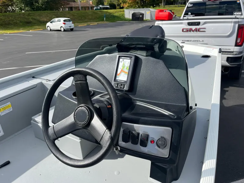 Slide: The Image of 2025 Crestliner 1600 Storm boat dashboard with steering wheel and navigation system. - 4
