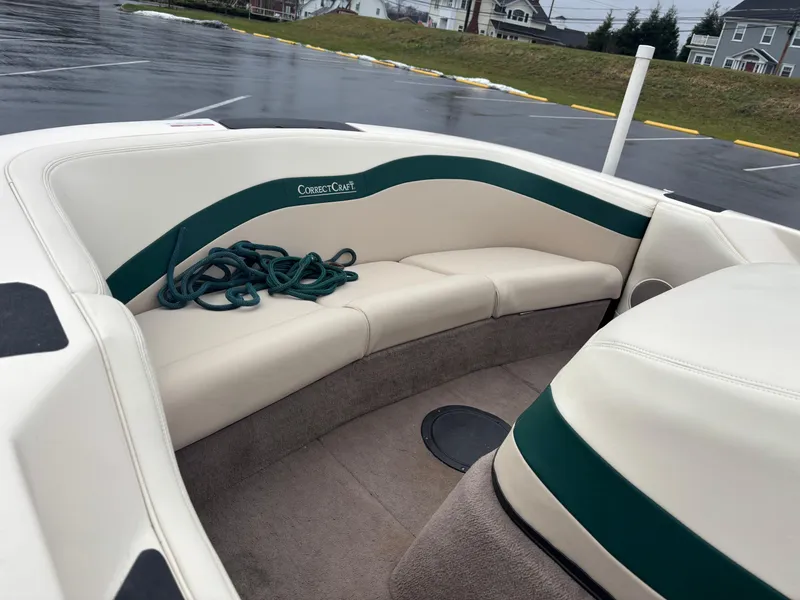 Slide: The Image of 1995 Correct Craft Ski Nautique boat interior with white and green seating. - 2