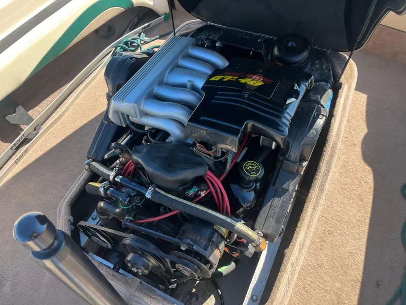 Slide: The Image of 1995 Correct Craft Ski Nautique engine with open cover, showcasing mechanical components. - 5