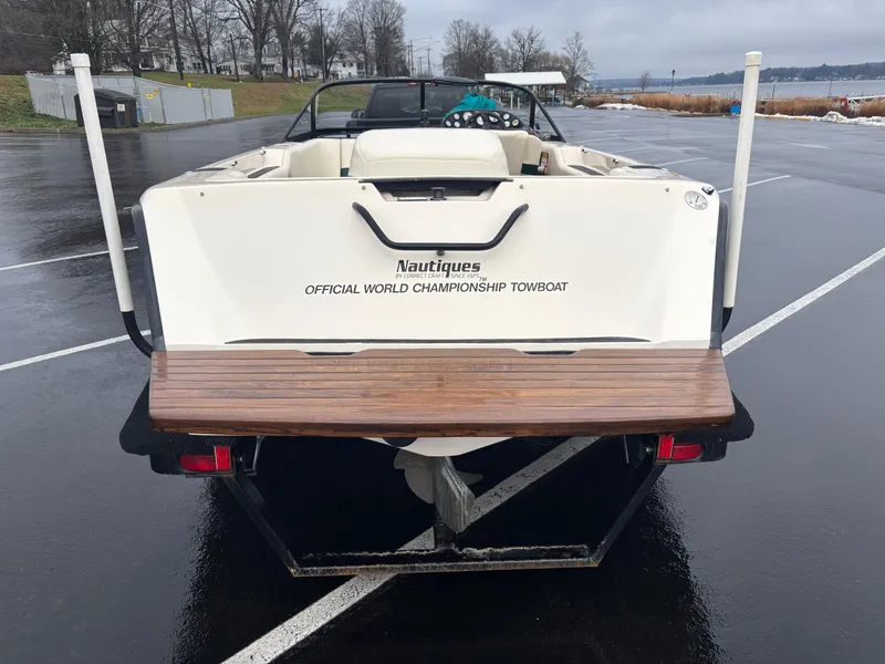 Slide: The Image of 1995 Correct Craft Ski Nautique boat on trailer, rear view in parking lot. - 8