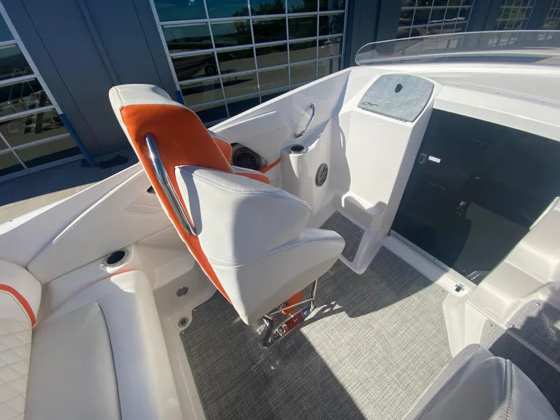 Slide: The Image of 2019 Baja 24 Outlaw boat interior with white and orange seating, modern design. - 15