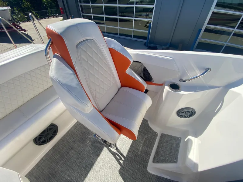 Slide: The Image of 2019 Baja 24 Outlaw boat interior with white and orange seating. - 19
