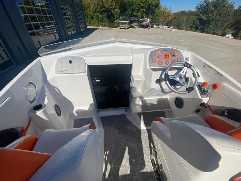 Slide: The Image of 2019 Baja 24 Outlaw boat interior with white and orange seating, modern dashboard. - 20