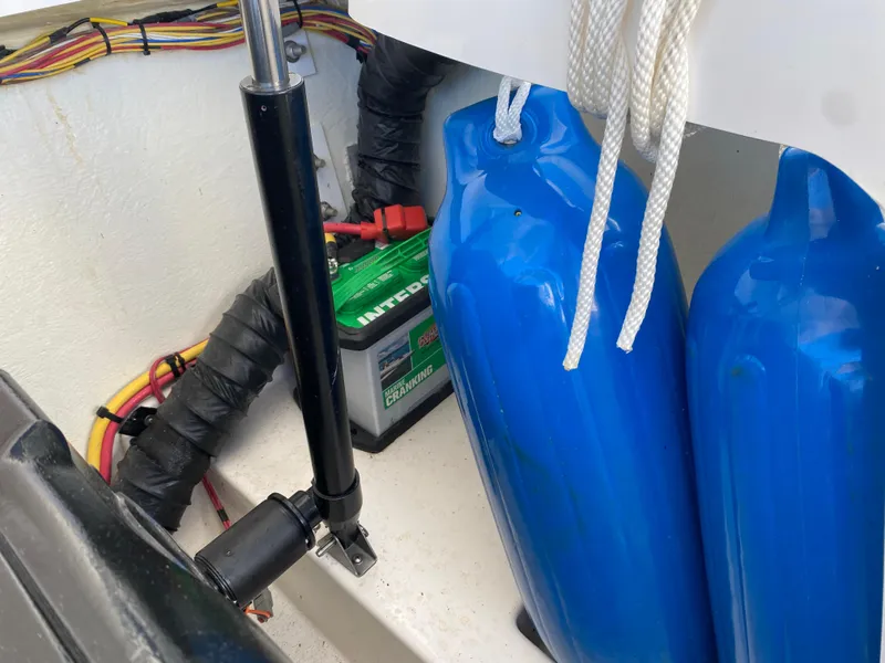 Slide: The Image of 2019 Baja 24 Outlaw boat interior with battery and blue fenders. - 28