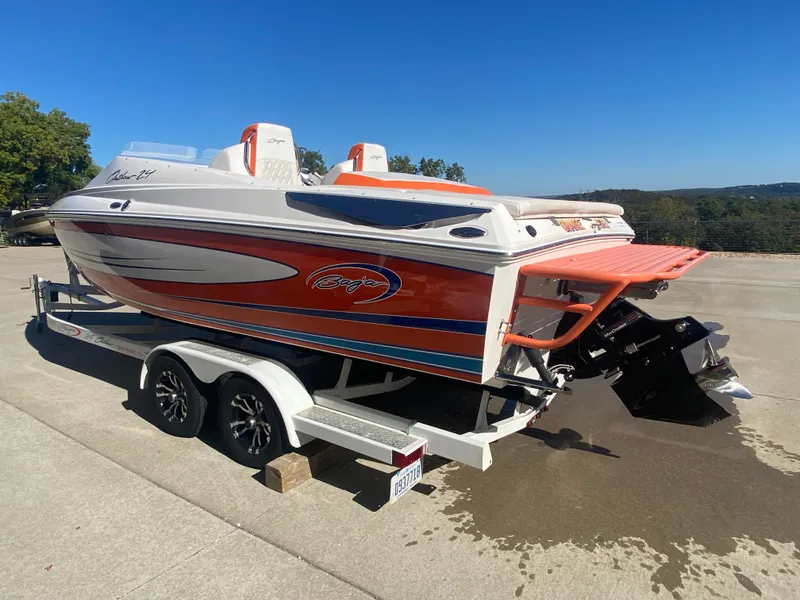 Slide: The Image of 2019 Baja 24 Outlaw speedboat on trailer, vibrant orange and white design. - 3
