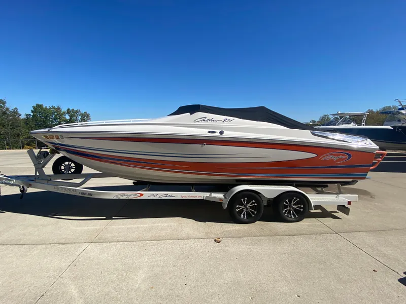Slide: The Image of 2019 Baja 24 Outlaw boat on trailer, vibrant orange and white design. - 32