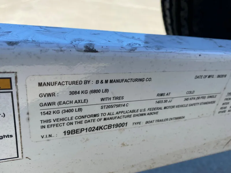 Slide: The Image of Label on a 2019 Baja 24 Outlaw boat trailer detailing specifications and compliance information. - 5