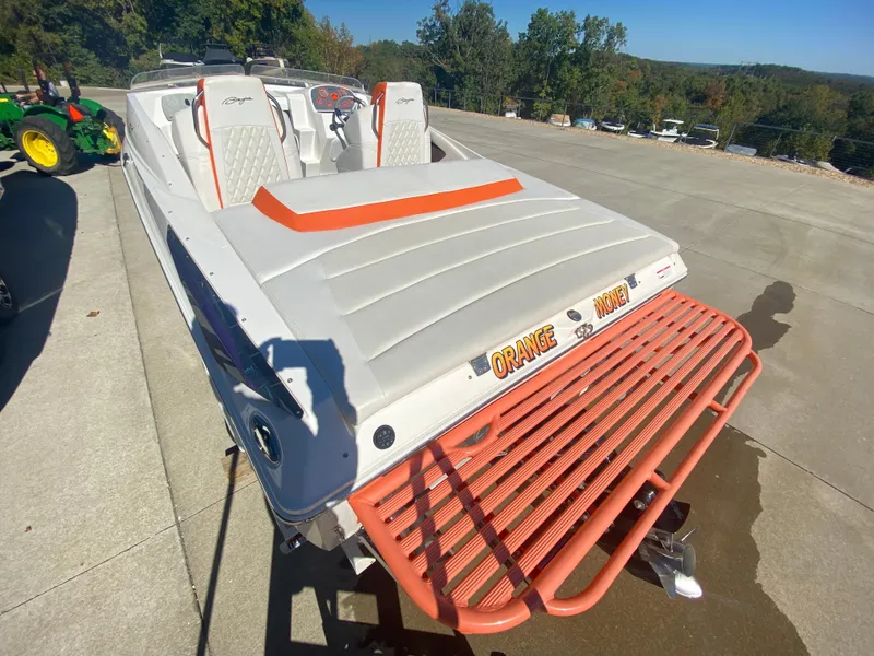 Slide: The Image of 2019 Baja 24 Outlaw boat with orange accents on a sunny day. - 6