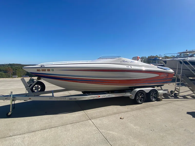 Slide: The Image of 2019 Baja 24 Outlaw speedboat on trailer under clear blue sky. - 8