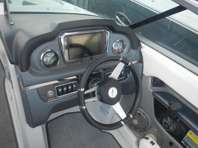 Slide: The Image of 2020 Chaparral 24 SSI boat dashboard with steering wheel and control panel. - 11