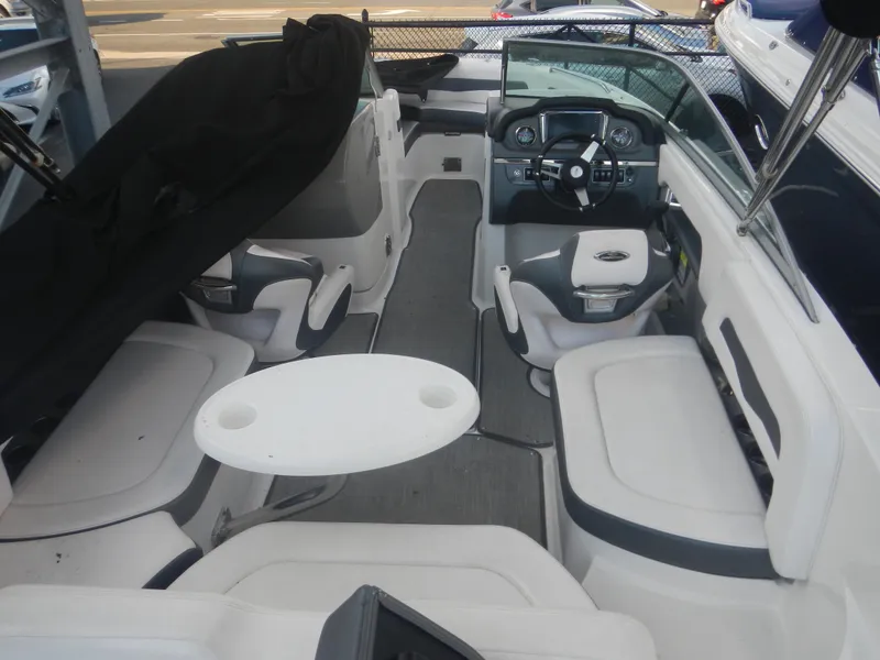 Slide: The Image of 2020 Chaparral 24 SSI boat interior with seating and steering console. - 12