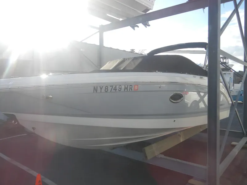 Slide: The Image of 2020 Chaparral 24 SSI boat on a storage rack, side view. - 2