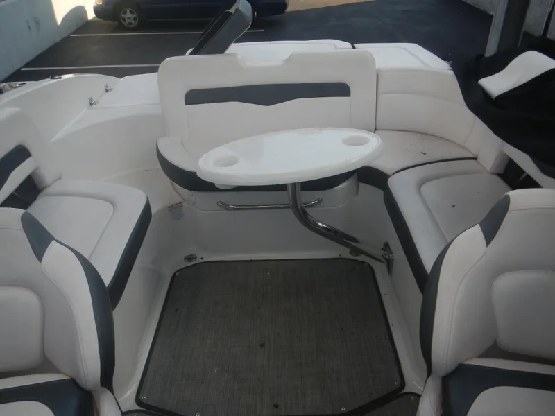 Slide: The Image of 2020 Chaparral 24 SSI boat interior with white seating and a small table. - 5