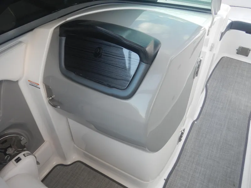 Slide: The Image of 2020 Chaparral 24 SSI boat interior with sleek storage compartment and modern design. - 9