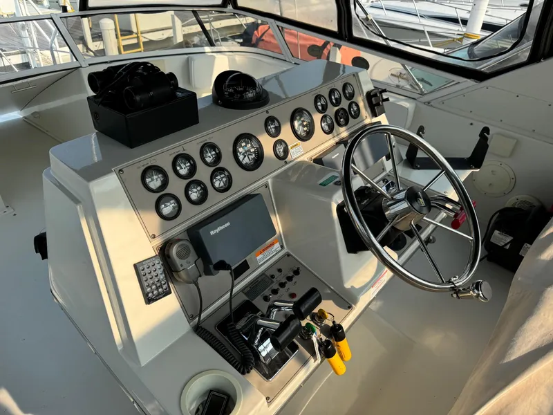 Slide: The Image of 1997 Carver 380 Santego SE boat helm with gauges and steering wheel. - 15