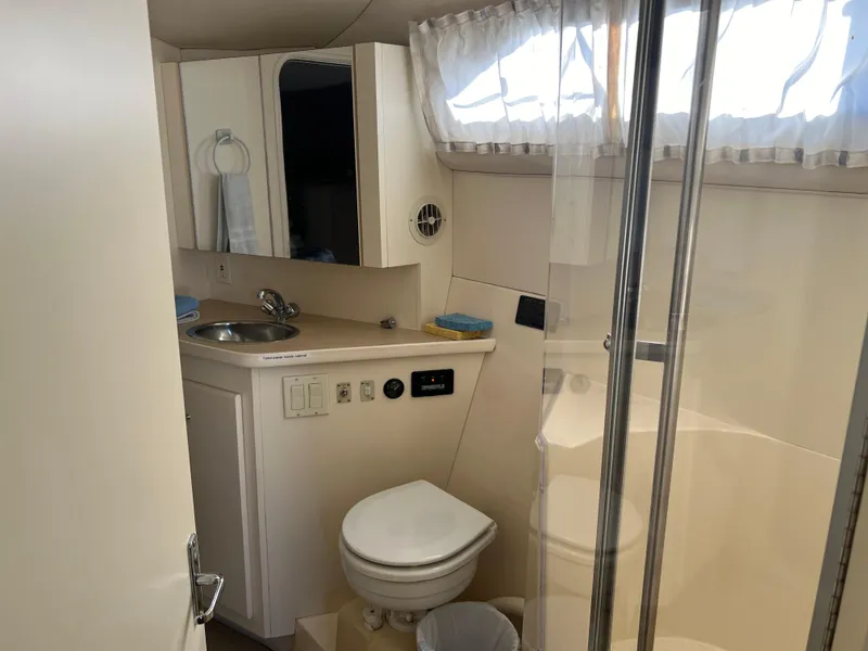 Slide: The Image of 1997 Carver 380 Santego SE yacht bathroom with shower, sink, and toilet. - 17